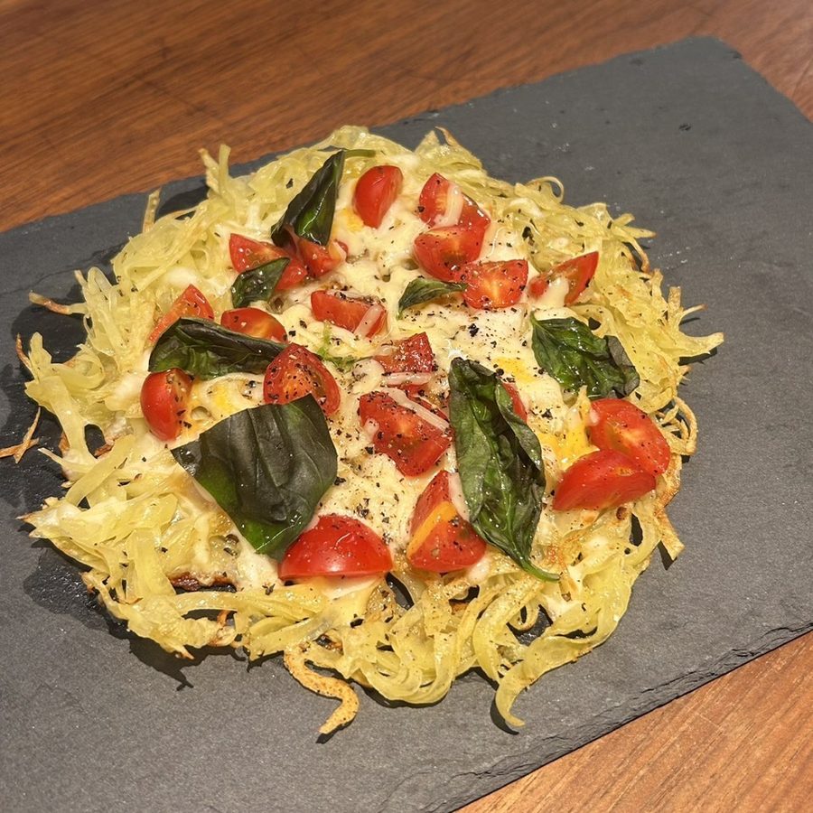 Potato galette with mozzarella, cherry tomatoes and basil
